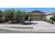 Charming single-story home featuring desert landscaping, a two-car garage, and a welcoming walkway at 16930 W Woodlands Ave, Goodyear, AZ 85338