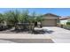 Inviting home with drought-tolerant landscaping, front gate, and attached two-car garage at 16930 W Woodlands Ave, Goodyear, AZ 85338