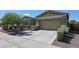 Lovely single-level home with desert landscaping, a two-car garage, and a paved driveway at 16930 W Woodlands Ave, Goodyear, AZ 85338