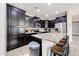 Kitchen featuring granite countertops, dark wood cabinets, and stainless steel appliances at 16930 W Woodlands Ave, Goodyear, AZ 85338