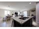 Open concept showcasing a dining area and living room visible from the kitchen sink at 16930 W Woodlands Ave, Goodyear, AZ 85338