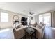 Bright living room featuring tile floors, comfortable seating, and a large sliding glass door at 16930 W Woodlands Ave, Goodyear, AZ 85338
