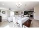 Open-concept living space combining dining and living areas with modern finishes and lots of natural light at 16930 W Woodlands Ave, Goodyear, AZ 85338