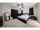 Main bedroom with carpet, ceiling fan, and dark furniture at 16930 W Woodlands Ave, Goodyear, AZ 85338