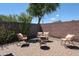 A quaint outdoor patio features comfortable seating, fire pit, and brick paving at 16930 W Woodlands Ave, Goodyear, AZ 85338