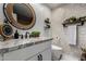 Chic powder room boasting decorative wallpaper, round mirror and granite countertop vanity at 1884 E Stephens Dr, Tempe, AZ 85283