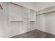 Spacious walk-in closet with built-in shelving and wooden rods for ample storage at 1884 E Stephens Dr, Tempe, AZ 85283
