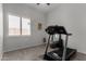 Bright exercise room features a treadmill, mirror, and window with shutter blinds at 1884 E Stephens Dr, Tempe, AZ 85283