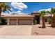 Charming home showcasing a three-car garage, landscaped front yard, and a welcoming entrance at 1884 E Stephens Dr, Tempe, AZ 85283