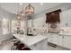 Elegant kitchen featuring white countertops, wooden pendant lights, island with bar stools, and decorative backsplash at 1884 E Stephens Dr, Tempe, AZ 85283
