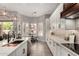 Well-lit kitchen with stainless steel appliances, island with sink, granite countertops, and backyard view at 1884 E Stephens Dr, Tempe, AZ 85283