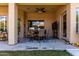 Covered patio with outdoor seating, ceiling fan, and serene backyard view at 1884 E Stephens Dr, Tempe, AZ 85283