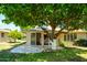 Enjoy outdoor living on this property with a covered patio and a large, mature tree in the backyard at 19030 N Signal Butte Cir, Sun City, AZ 85373
