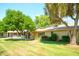A beautifully maintained backyard with a lush green lawn, mature trees, and a tranquil atmosphere at 19030 N Signal Butte Cir, Sun City, AZ 85373