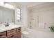 Well-lit bathroom featuring a shower-tub combination, classic vanity, and tasteful decor at 19030 N Signal Butte Cir, Sun City, AZ 85373