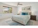 Cozy bedroom featuring a comfortable bed with stylish decor, a ceiling fan, and natural light at 19030 N Signal Butte Cir, Sun City, AZ 85373