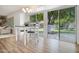 Dining area featuring wood floors, modern table, chairs, and sliding glass doors leading to the backyard at 19030 N Signal Butte Cir, Sun City, AZ 85373