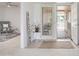 Inviting entryway with tiled floors, a 'WELCOME' sign and a view into the living room at 19030 N Signal Butte Cir, Sun City, AZ 85373