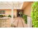 Inviting covered entrance with lush landscaping and a view into the home at 19030 N Signal Butte Cir, Sun City, AZ 85373