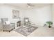 Bright living room with plush chairs, glass coffee table, and neutral decor at 19030 N Signal Butte Cir, Sun City, AZ 85373