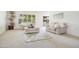 Bright living room featuring neutral carpet, two sofas, and a large window at 19030 N Signal Butte Cir, Sun City, AZ 85373