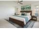 Spacious main bedroom with ensuite bath featuring a plush bed, wood furniture, and neutral carpet at 19030 N Signal Butte Cir, Sun City, AZ 85373
