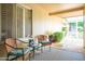 Charming covered patio with comfortable seating and a view of the lush surroundings at 19030 N Signal Butte Cir, Sun City, AZ 85373