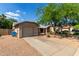 View of a single-Gathering home with a gravel yard, shade tree, and attached two-car garage at 1926 E Sandra Ter, Phoenix, AZ 85022