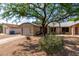 Residential house with xeriscaping, a mature shade tree, and an attached two-car garage at 1926 E Sandra Ter, Phoenix, AZ 85022