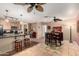 Bright living room featuring tile flooring, ceiling fan and bar seating into kitchen at 1926 E Sandra Ter, Phoenix, AZ 85022