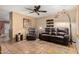Inviting living room featuring a plush leather sofa, terracotta floors, and a ceiling fan at 1926 E Sandra Ter, Phoenix, AZ 85022