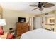 Bright main bedroom featuring tile flooring, ceiling fan and adjacent main bathroom at 1926 E Sandra Ter, Phoenix, AZ 85022