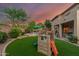 Beautiful backyard featuring artificial turf, a splash pool, and playset at 194 E Canyon Creek Dr, Gilbert, AZ 85295