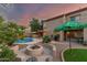 Outdoor fire pit, patio seating, an in-ground pool, and lush landscaping define this backyard at 194 E Canyon Creek Dr, Gilbert, AZ 85295