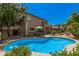 Spacious backyard featuring a private in-ground pool, covered patio, and well-maintained landscaping at 194 E Canyon Creek Dr, Gilbert, AZ 85295