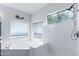Bright bathroom featuring a soaking tub, decorative flower, and walk-in shower at 194 E Canyon Creek Dr, Gilbert, AZ 85295
