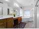 Bright bathroom featuring a soaking tub, wood cabinets, and neutral tile floor at 194 E Canyon Creek Dr, Gilbert, AZ 85295