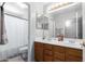 Bathroom featuring a double sink vanity, wood cabinets, and tub with shower at 194 E Canyon Creek Dr, Gilbert, AZ 85295