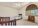 A bedroom featuring neutral colored walls, vaulted ceiling, and window with blinds at 194 E Canyon Creek Dr, Gilbert, AZ 85295