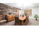 Charming dining room featuring rustic wood wall, wood table, and comfortable striped chairs at 194 E Canyon Creek Dr, Gilbert, AZ 85295