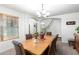 Elegant dining room with a chandelier and wood table, open to the living area with view of staircase at 194 E Canyon Creek Dr, Gilbert, AZ 85295