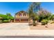 Charming two-story home featuring a three-car garage, well-maintained landscaping, and a spacious driveway at 194 E Canyon Creek Dr, Gilbert, AZ 85295