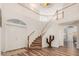Grand foyer features a curved staircase and wood-look flooring at 194 E Canyon Creek Dr, Gilbert, AZ 85295