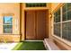 Charming double front doors with decorative accents, creating an inviting entry to the home and a covered bench at 194 E Canyon Creek Dr, Gilbert, AZ 85295