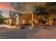 Lovely home with attractive landscaping, exterior lighting, and mature trees, creating an inviting curb appeal at 194 E Canyon Creek Dr, Gilbert, AZ 85295
