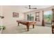 Game room with pool table features sliding glass doors to the outdoor balcony at 194 E Canyon Creek Dr, Gilbert, AZ 85295