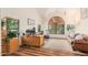 Bright home office with wood floors, vaulted ceiling, a desk, and comfortable leather sofa at 194 E Canyon Creek Dr, Gilbert, AZ 85295