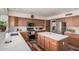 Modern kitchen with wood cabinets, stainless steel appliances, and a large island with a white countertop at 194 E Canyon Creek Dr, Gilbert, AZ 85295
