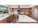 A well-equipped kitchen featuring stainless steel appliances, wood cabinets, and a white island at 194 E Canyon Creek Dr, Gilbert, AZ 85295