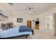 A cozy main bedroom featuring a comfortable bed, mounted television, ceiling fan, and a view of the staircase at 194 E Canyon Creek Dr, Gilbert, AZ 85295